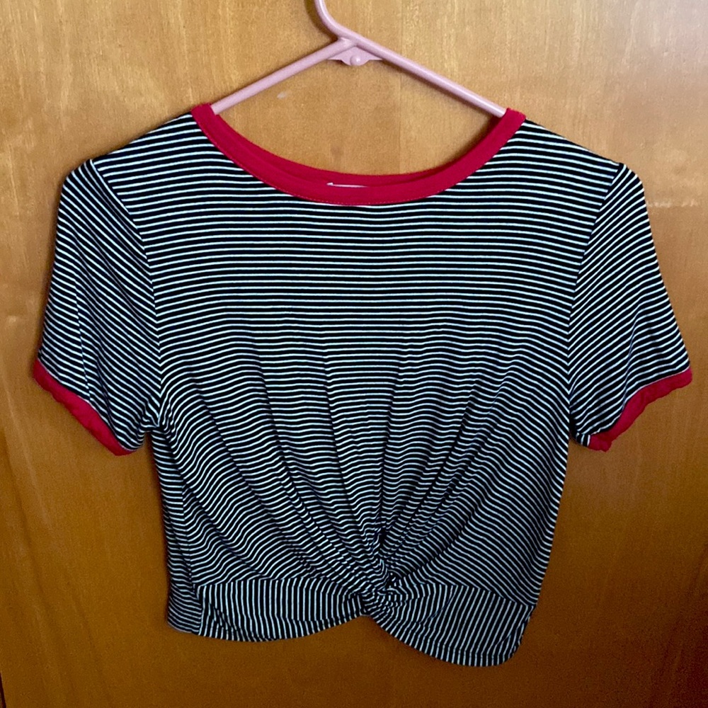 A black and white striped crop top with a knot in the middle of the shirt.
